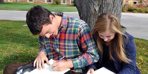 Students writing outdoors